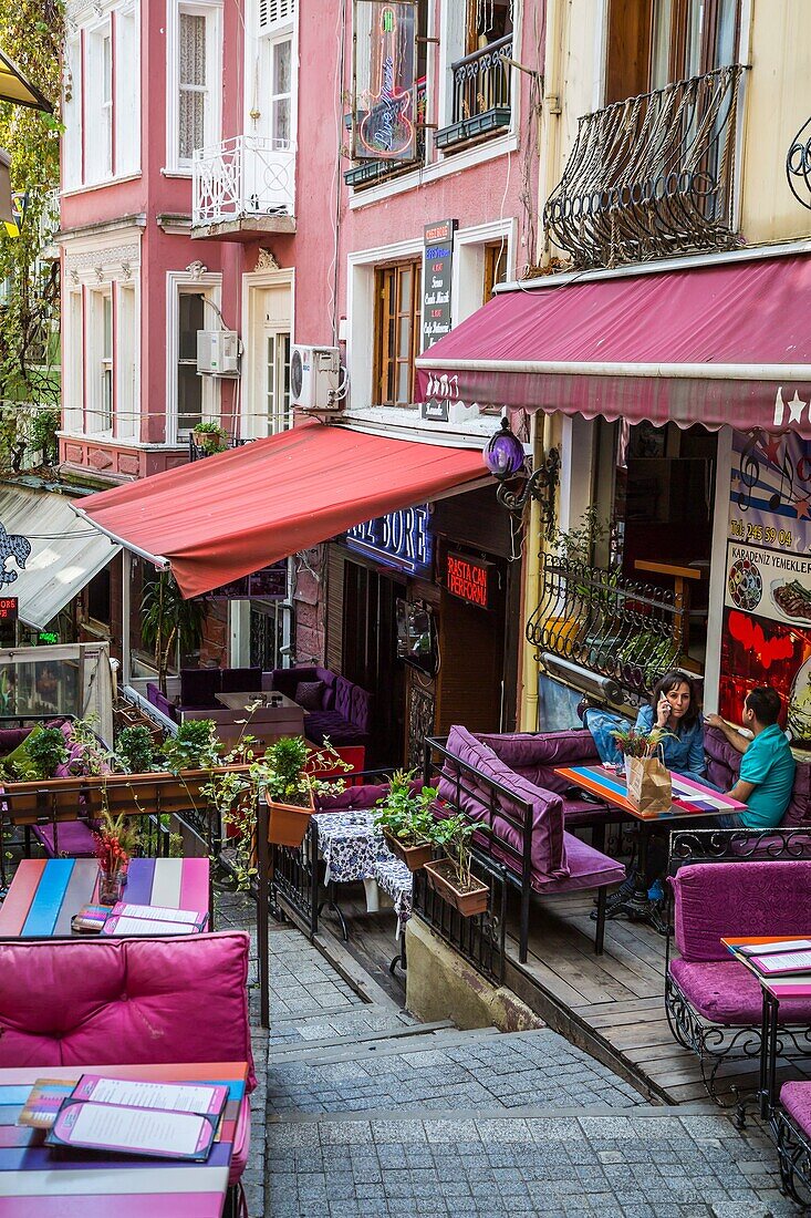 Colorful restaurants with tables and chairs and the unique Cezayir or French Street in Taksim, Istanbul, Turkey, Eurasia.