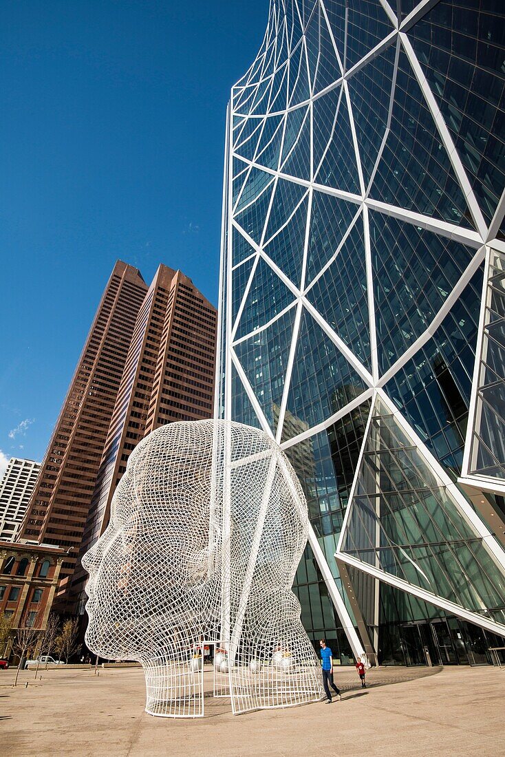 'The Bow, office building in Calgary, Alberta, Canada. Design by Norman Foster, architect. ''Wonderland'', sculpture by Jaume Plensa.'