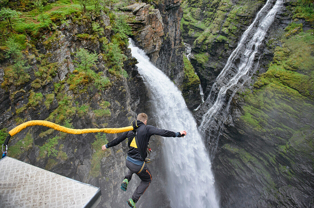 bungee jumping into a waterfall from the Gorsa Bridge in northern Norway.
