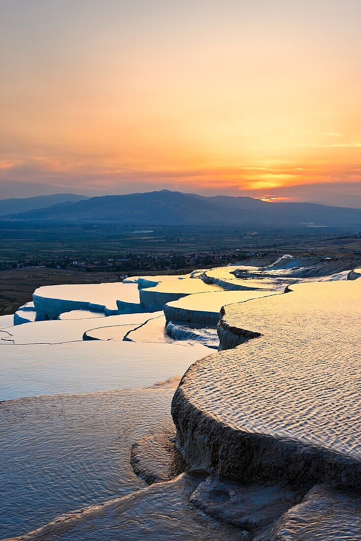 Travertine terraces of Pamukkale at sunset. Denizli Province, Turkey.