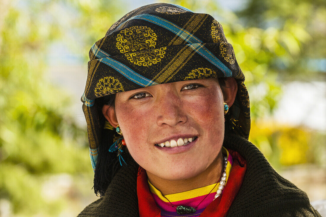 Woman wearing traditional dress from Shigatse, outside the Sera Monastery, outside Lhasa, Tibet (Xizang), China.