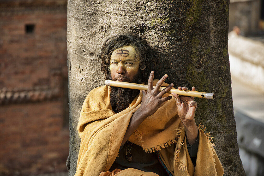 Sadhu playing his flute, Kathmandu, Nepal.