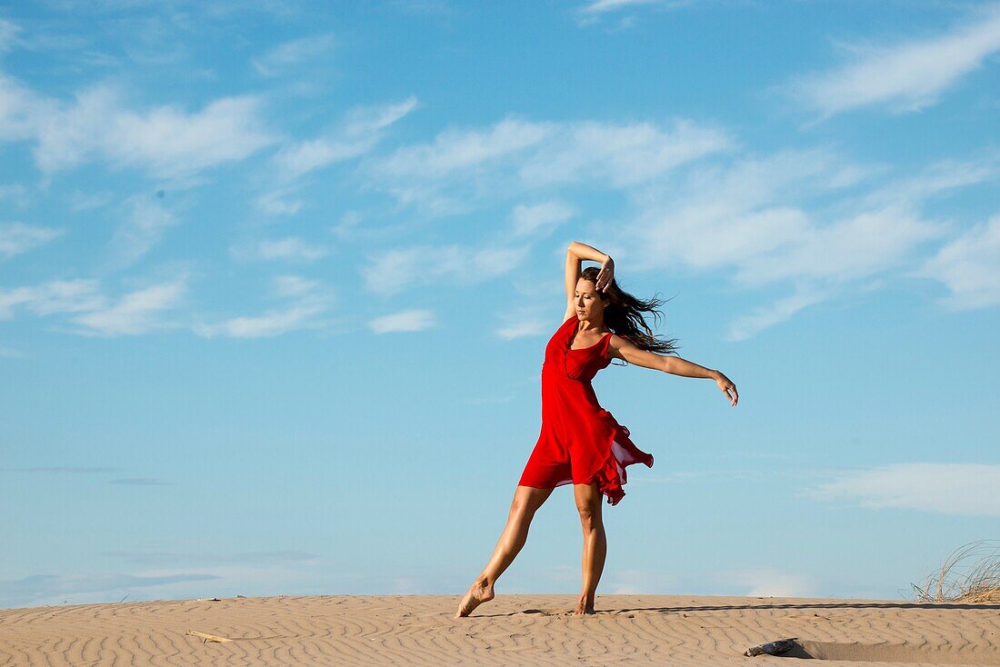 Ballet dancer dancing on the beach on toes