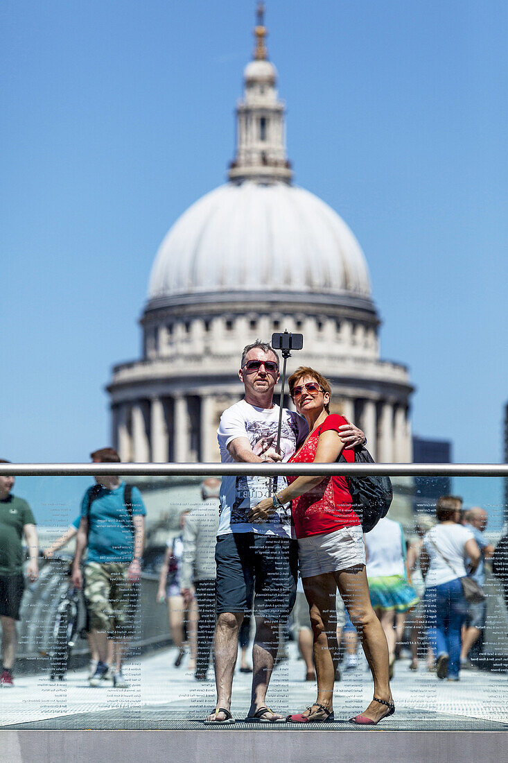 A Couple Photograph Themselves (selfie) On The Millennium Bridge With St Paul´s Cathedral In The Backround, London, England.