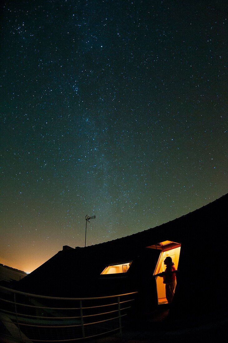France, Finistere 29, Moelan sur Mer, man watching from roof Milky Way stars