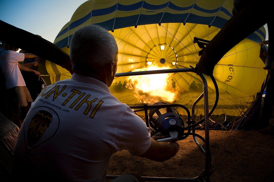 Airman heating a hot air balloon in European hot air balloon festival Igualada, Barcelona, Catalonia, Spain, Europe.