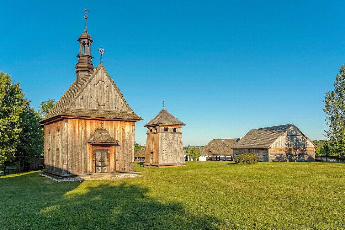 Church from Rogow and belfry from Kazimierza Wielka in Tokarnia open-air museum, Poland.