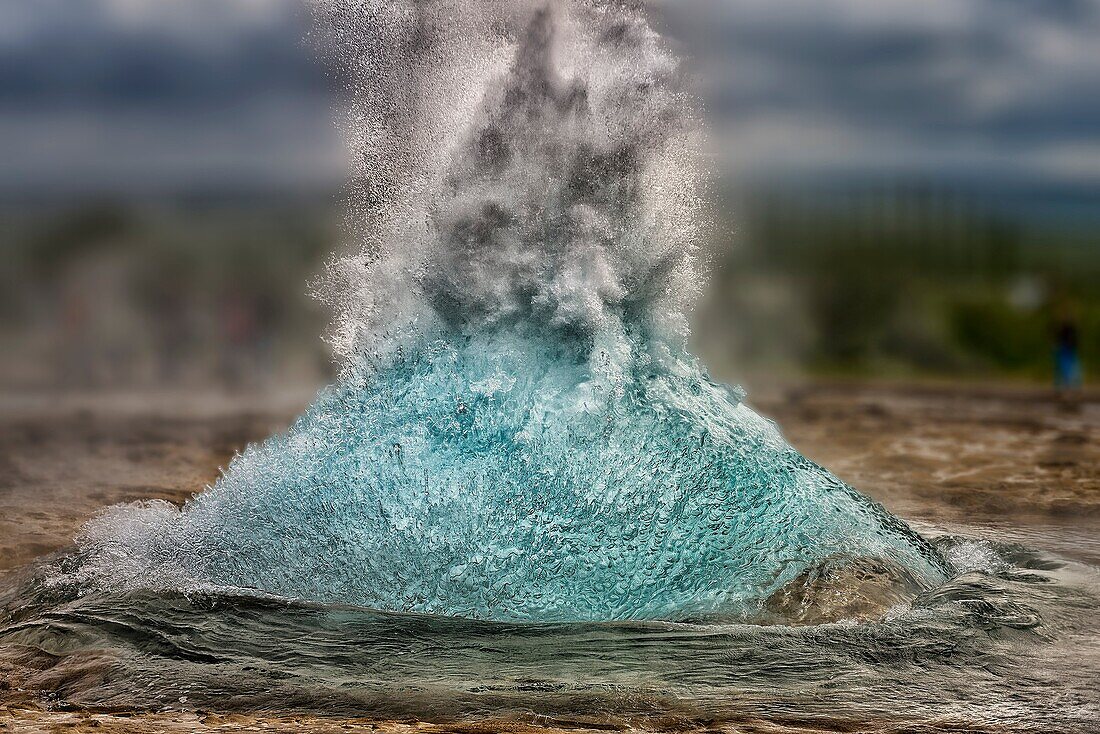 Strokkur Geyser just before it erupts, Iceland.Strokkur is a fountain geyser in the geothermal area beside the Hvita River in the Haukadalur valley, erupting about every 10 minutes or so. The white column of boiling water can reach as high as 20-30 meters