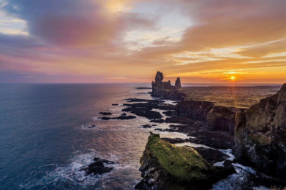 Londrangar sea stacks and the Thufubjarg cliffs. Londrangar-basalt volcanic dikes that formed after magma solidified, after years of erosion these sea stacks remain, Snaefellnes Peninsula, Iceland. Â  Londrangar sea stacks and the Thufubjarg cliffs. Londr