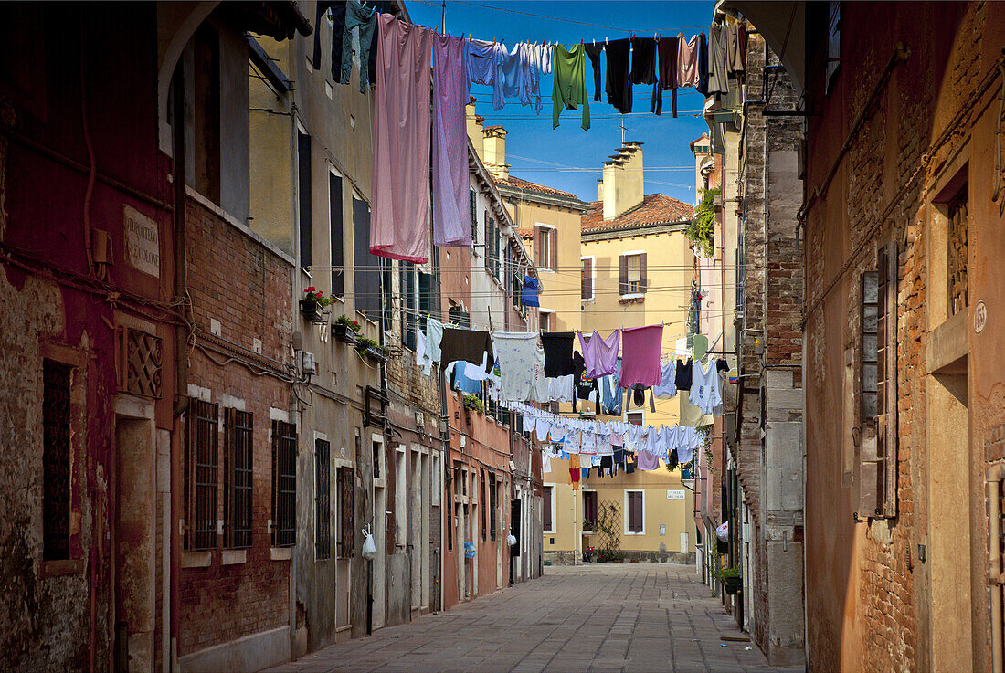 Laundry hanging across a narrow street in Venice, Italy.