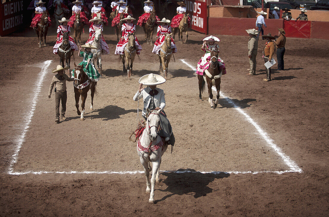 'Escaramuza teams enter the lienzo during an Escaramuza fair in the Lienzo Charros el Penon, Mexico City, Sunday, January 19, 2013. Escaramuzas are similar to US rodeos, where female competitors called ''''''''Amazonas'''''''' wear long skirts, and ride s