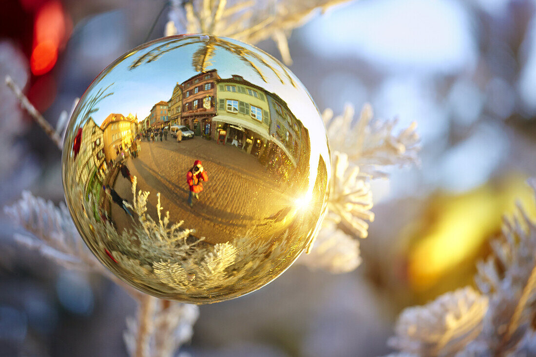 Typical half-timbering houses reflected on a Christmas bauble. Colmar. Haut-Rhin. Alsace. France.