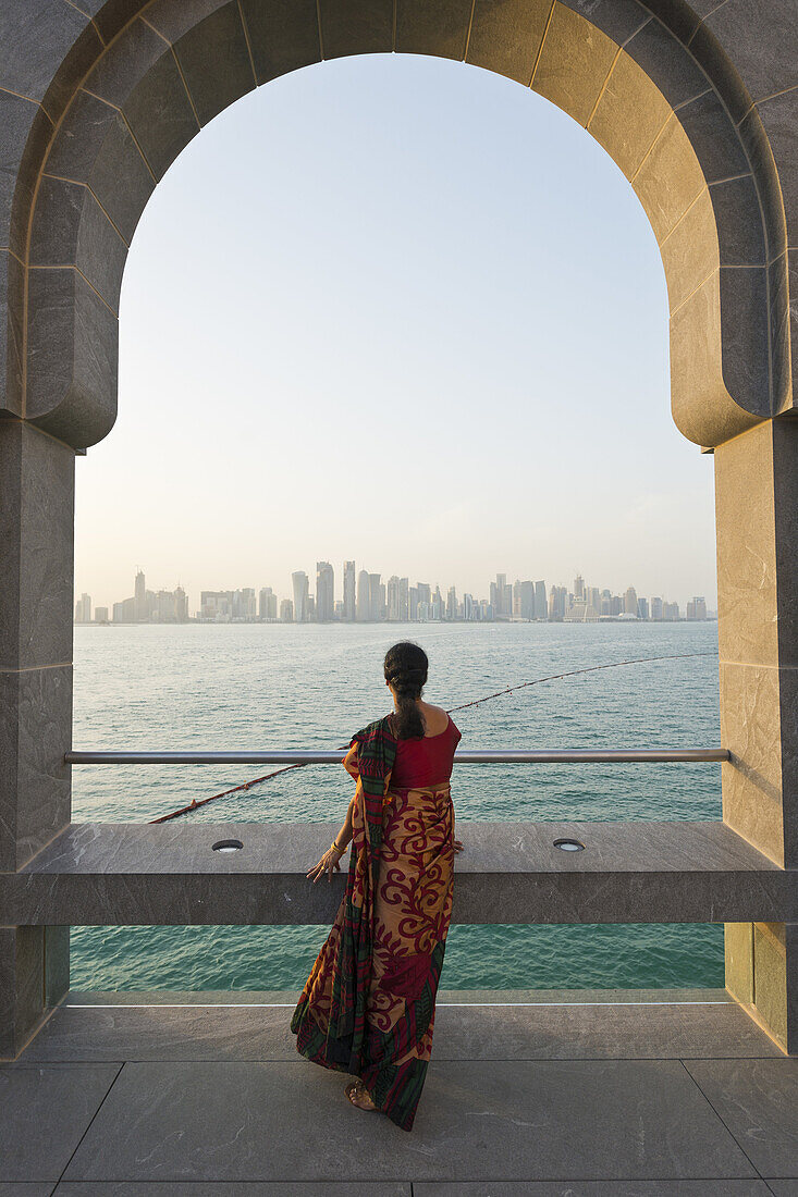 Doha. Qatar. Vistitor looking across Bay of Doha from the Museum of Islamic Art.