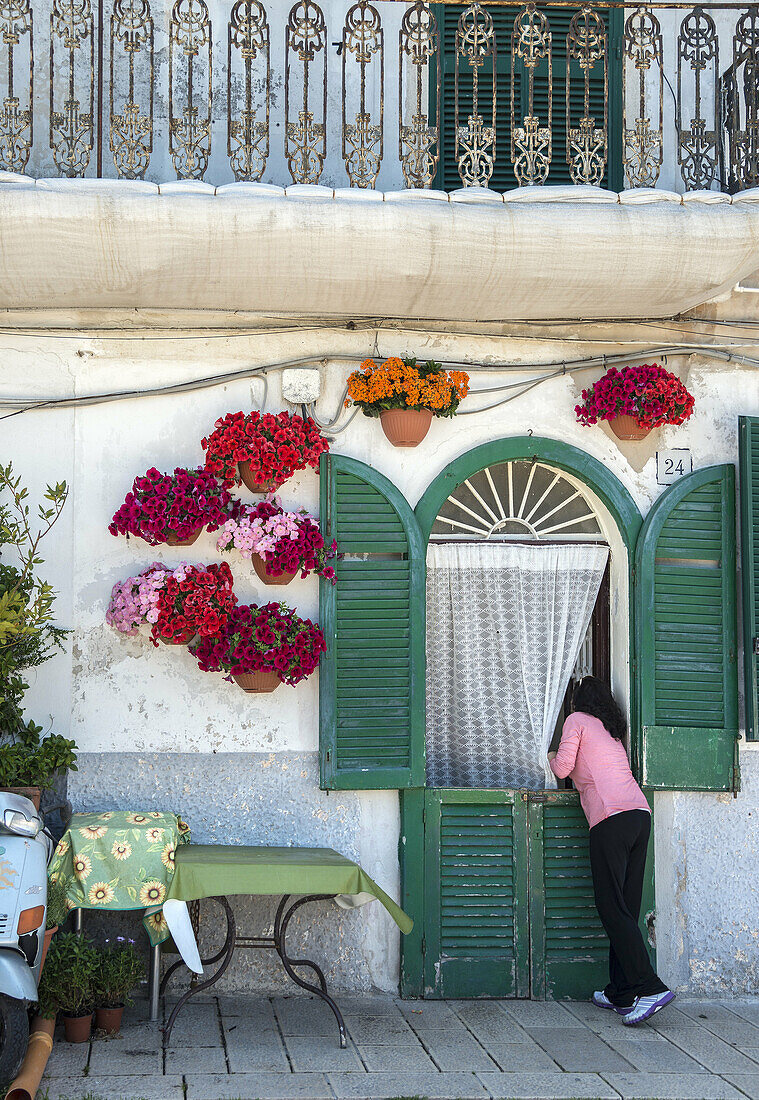 Flower baskets adorn the entrance to a house in Barivecchia, Bari old town, Puglia, Southern Italy.
