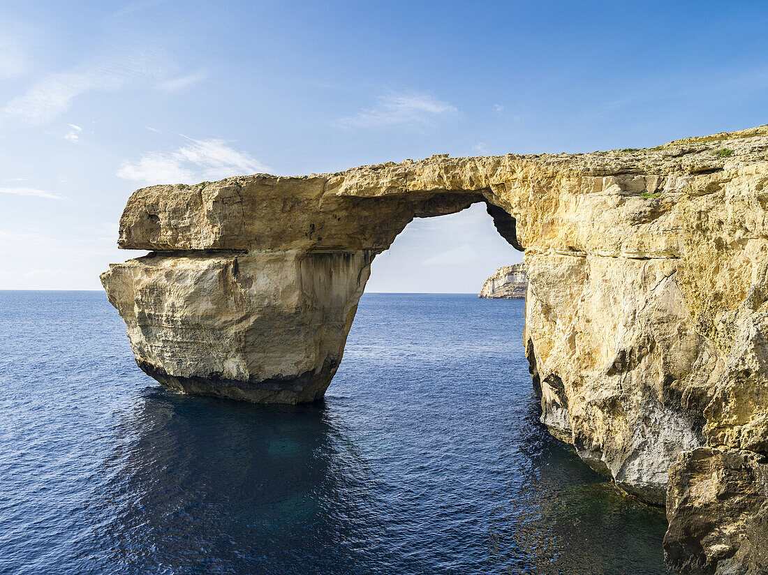 The island of Gozo in the maltese archipelago. Azure Window, an iconic natural arch or sea bridge at the coast of Gozo Europe, Southern Europe, Malta, April.