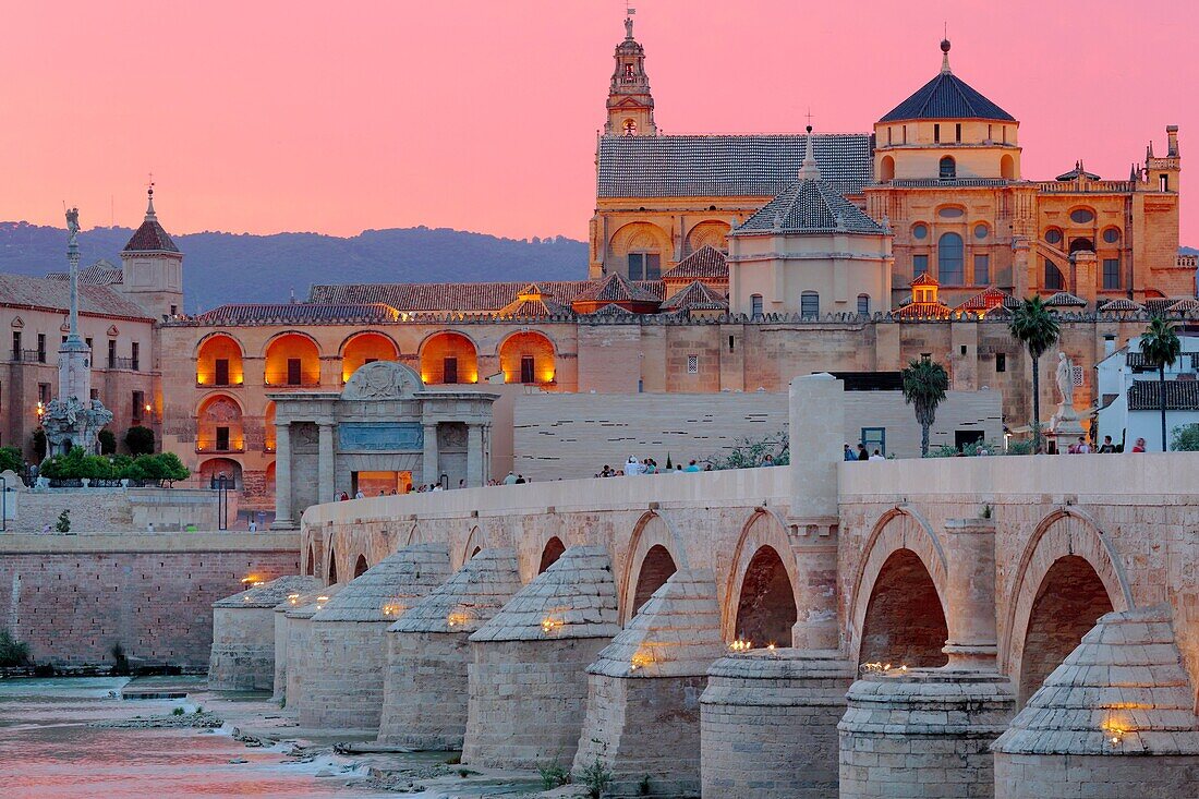 Cathedral (Mezquita) and Roman bridge at sunset, Guadalquivir river, Cordoba, Andalusia, Spain.