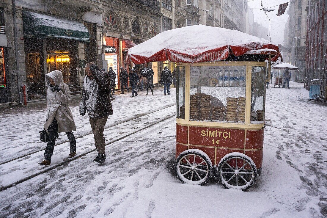 A simit bread stall during winter snow storm on Istiklal Caddesi, Beyoglu, Istanbul, Turkey,.