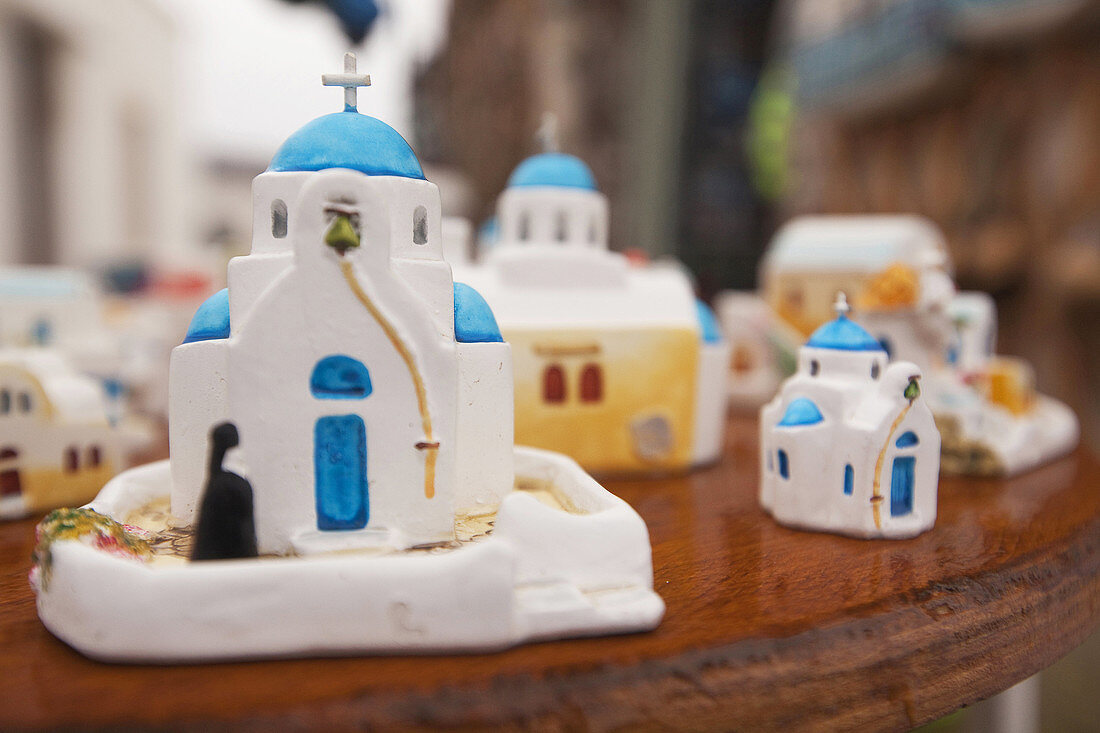 Souvenir blue domed church figurines on the bench for sell, Pyrgos, Santorini, Cyclades Islands, Greek Islands, Greece, Europe.