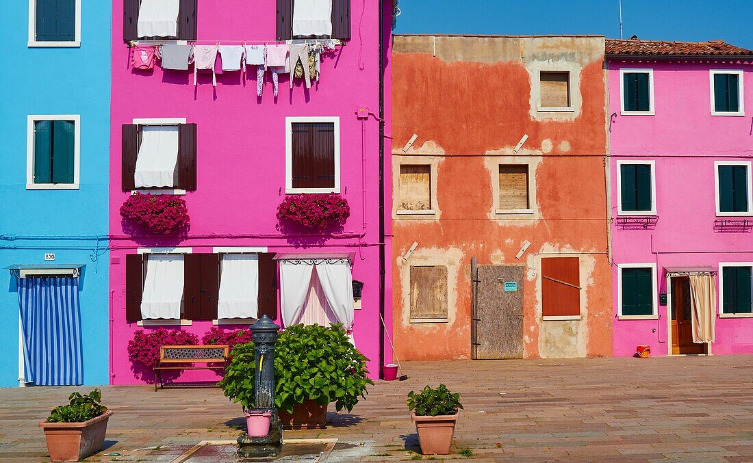 Brightly painted houses in pretty square, Burano, Venetian Lagoon, Veneto, Italy, Europe.