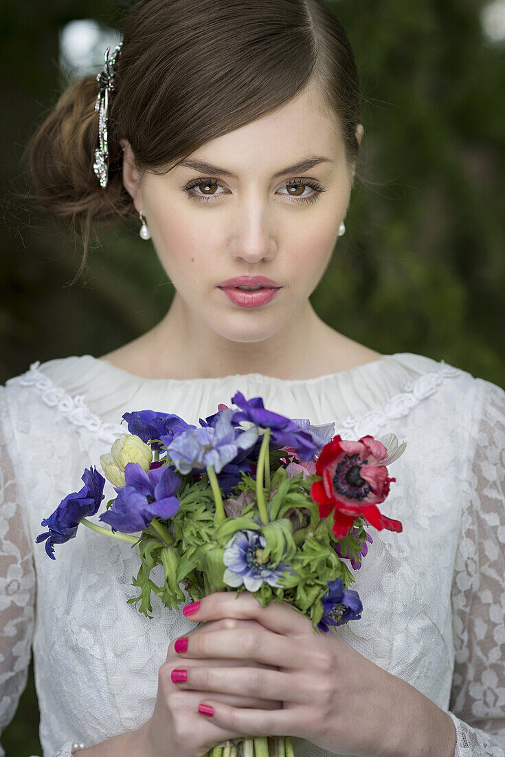 Junge Braut mit Wildblumenstrauß.
