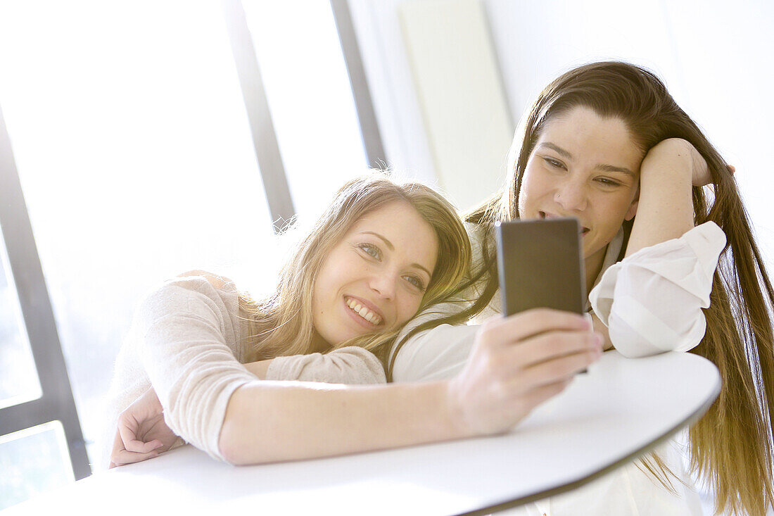 Two young women with smartphones