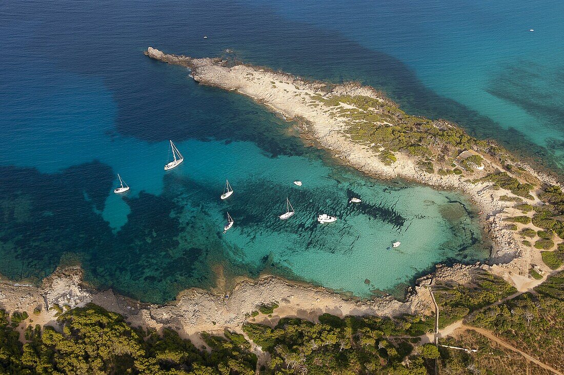 Aerial shot of a beach with anchored boats in the northeast of Mallorca (Majorca, Balearic Island).