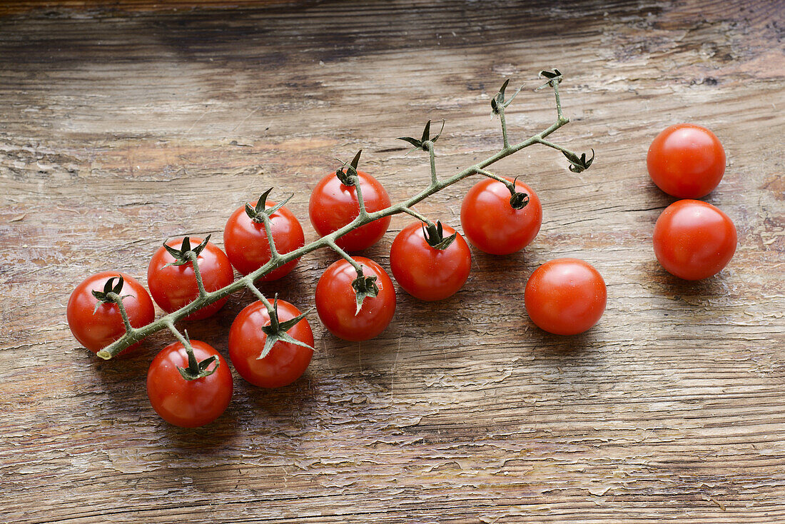 cherry tomatoes on a wooden background.