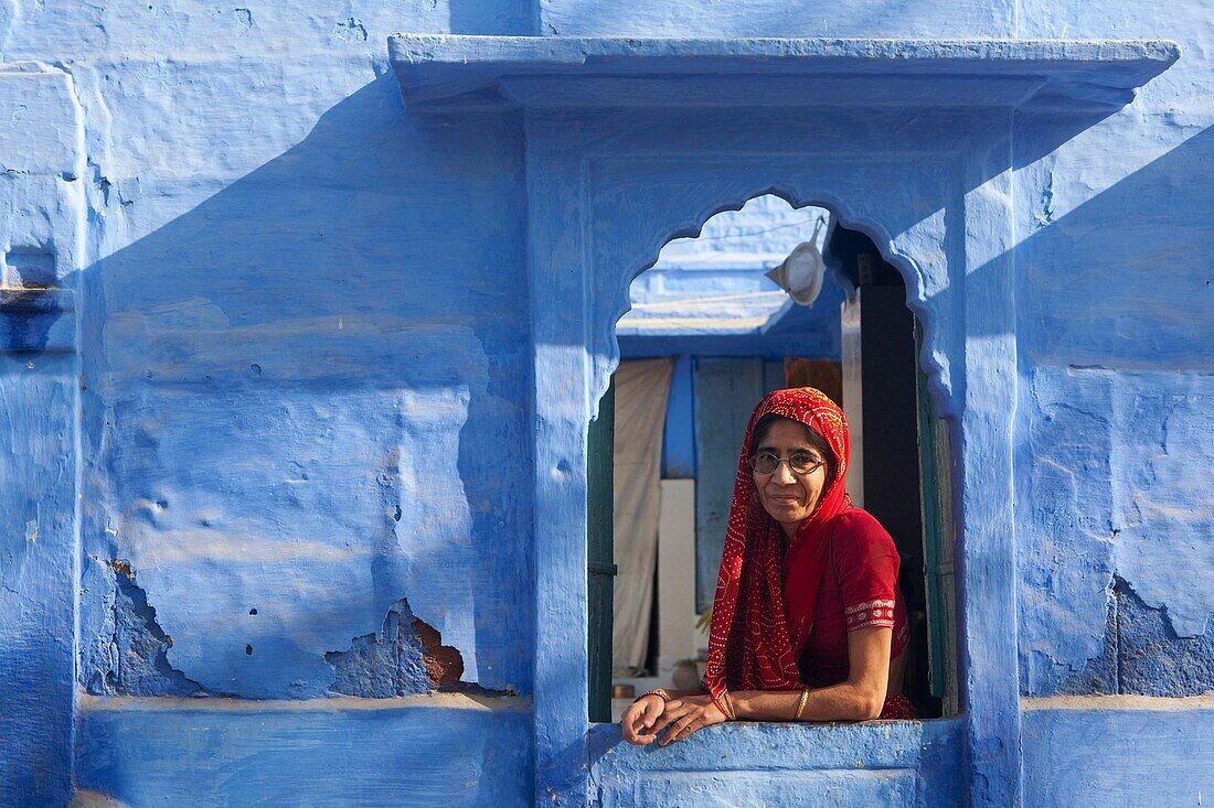 Portrait of Indian lady at window, Rajasthan, India.