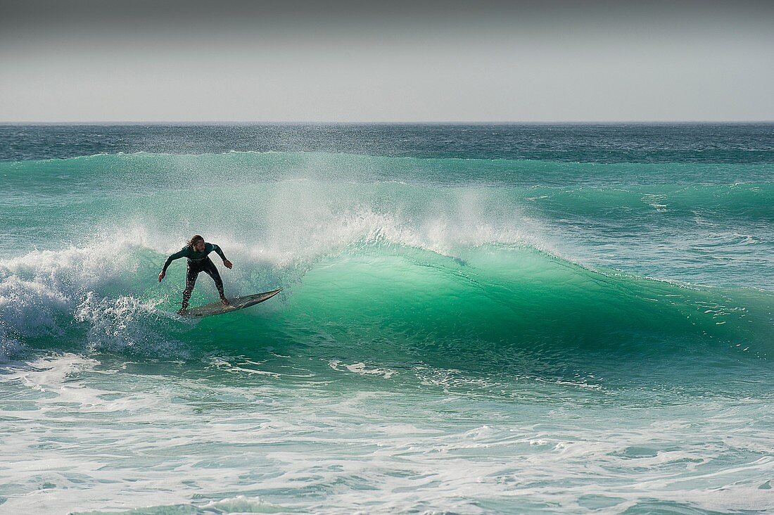 A surfer at Fistral in Newquay, Cornwall.