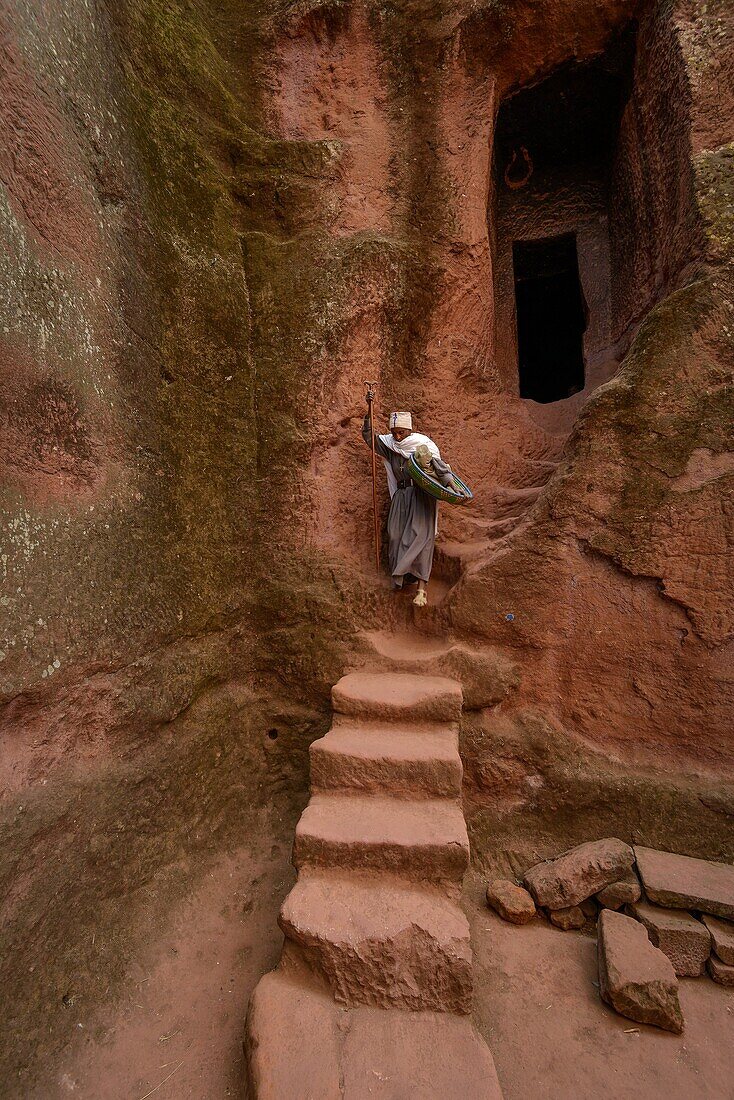 Woman on stairs at Bet (or Biete) Ammanuel ( House of Emmanuel). Rock Hewn Churche of Lalibela. Ethiopia.