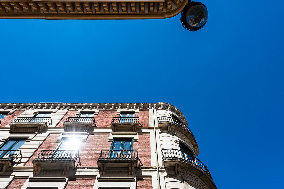 The sun reflected in a typical residential building in the city centre, Granada, Andalusia, Spain