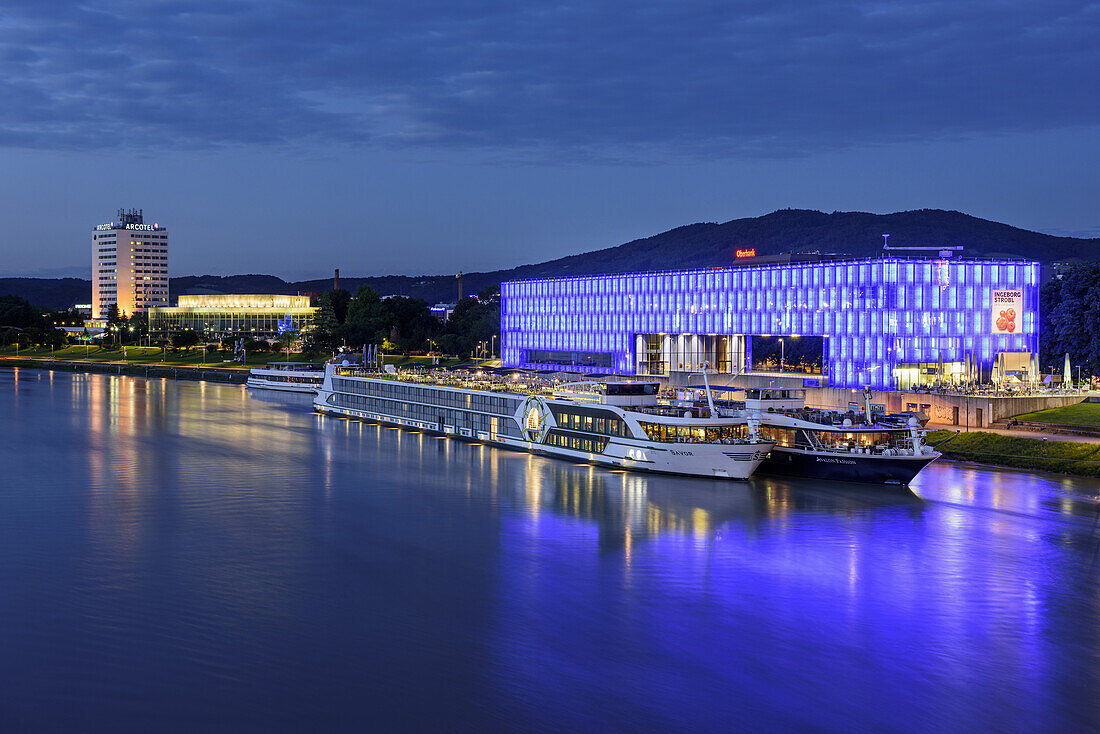 Ships at Danube laying in front of illuminated Lentos Museum, Linz, Danube Bike Trail, Upper Austria, Austria