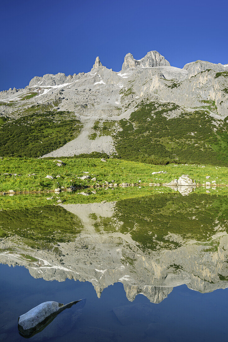 Drei Tuerme reflecting in mountain lake, Raetikon trail, Raetikon, Vorarlberg, Austria