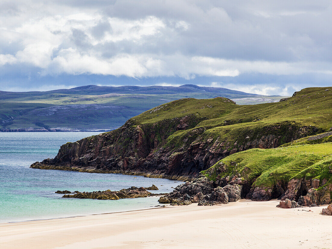 'White sand and rugged cliffs along the coastline of the Highlands; Scotland'