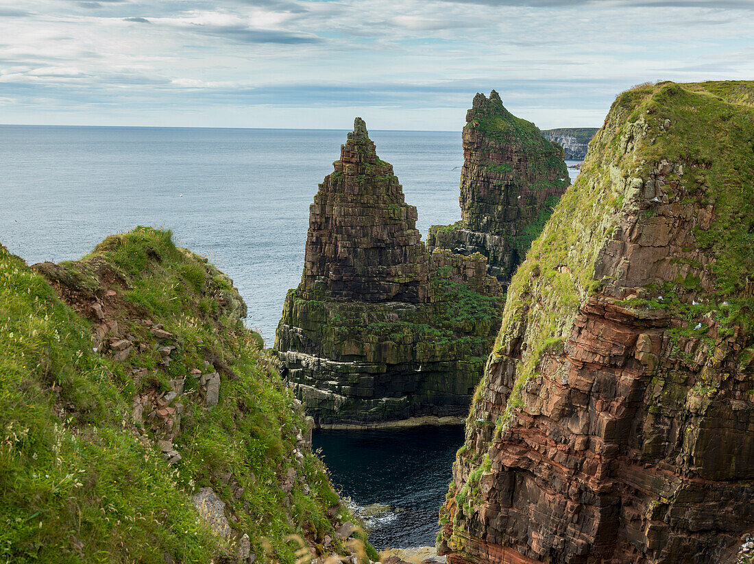 'Rugged peaked sea stacks along the coast of Duncansby Head; Scotland'