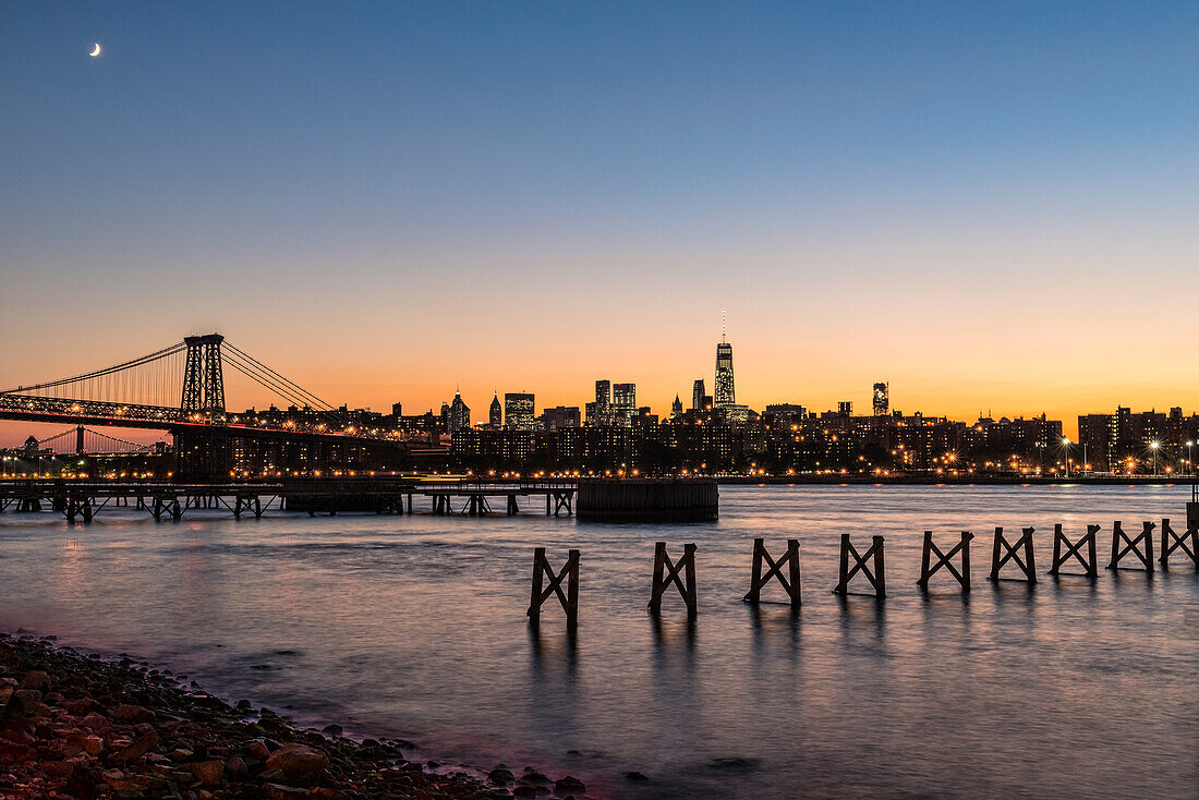 'Sunset over Lower Manhattan near World Trade Center and Williamsberg Bridge; Brooklyn, New York, United States of America'
