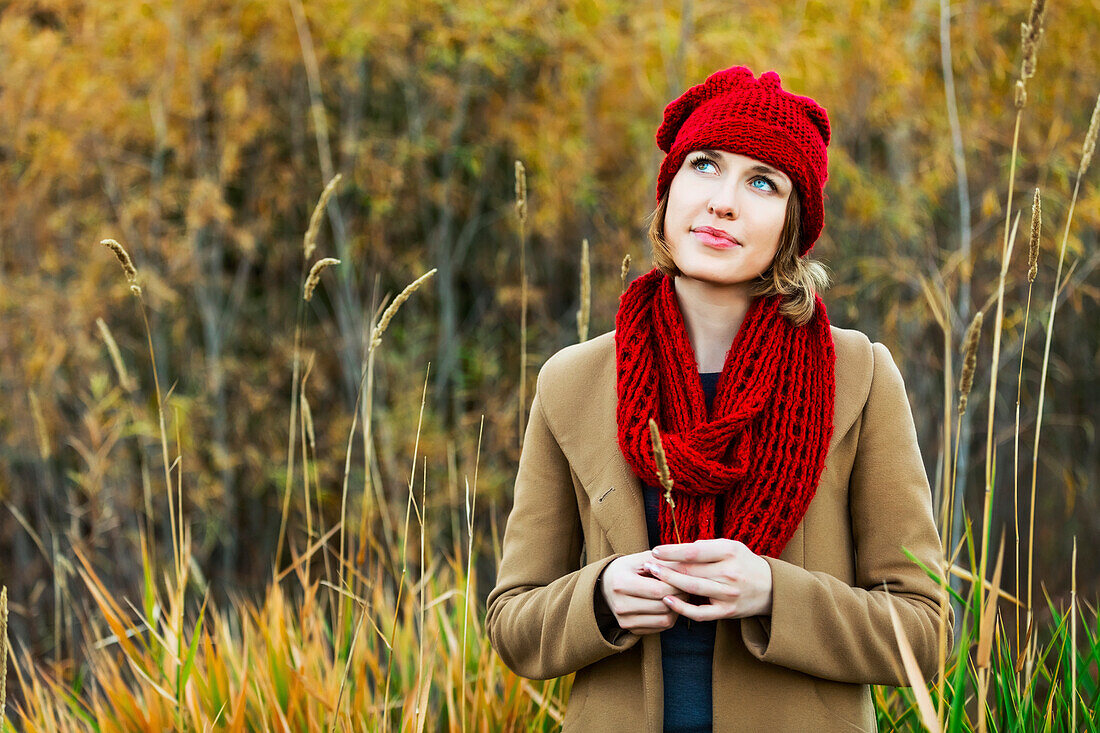 'Portrait of a young woman being very contemplative during an outing in a city park in autumn; Edmonton, Alberta, Canada'