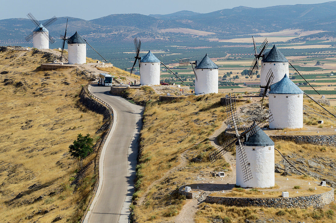 'Windmills in a row along a road; Consuegra, Spain'