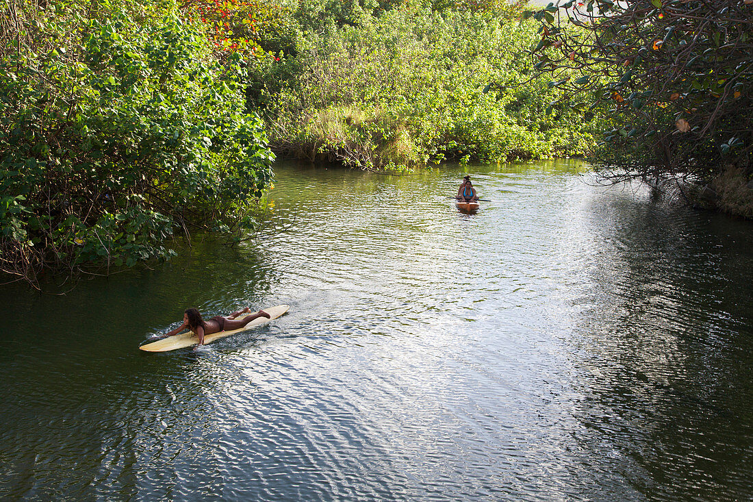 'Local children float down Punaluu Stream; Punaluu, Oahu, Hawaii, United States of America'