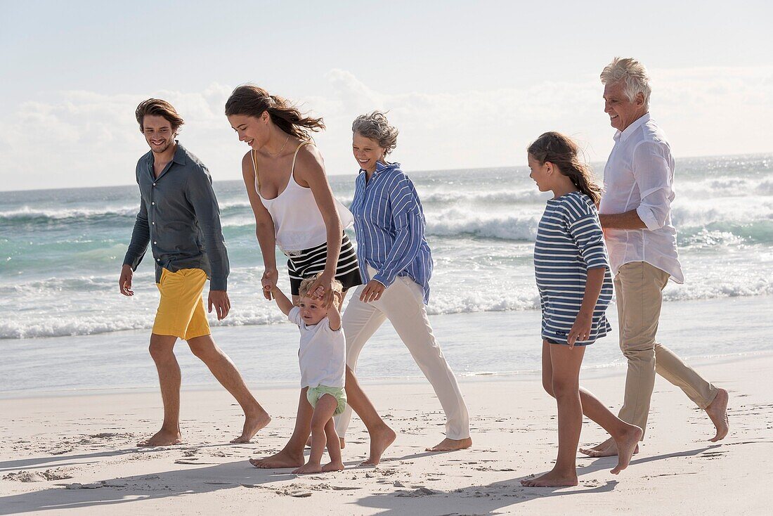 Happy multi-generation family enjoying on beach