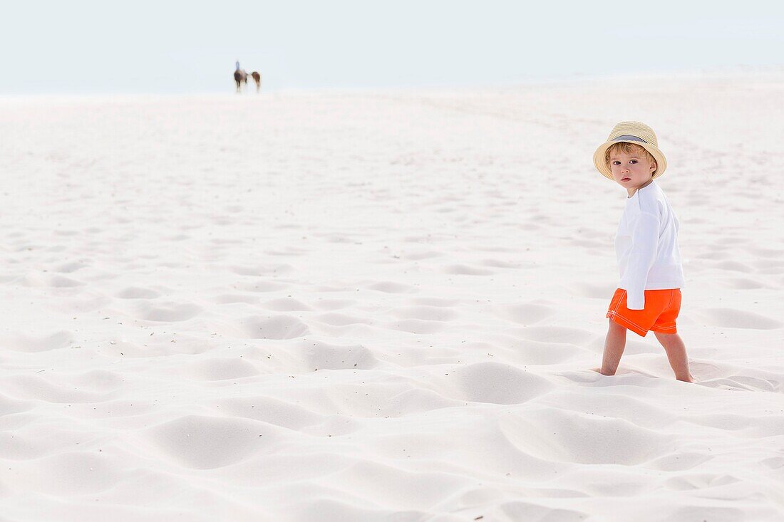 Baby boy standing on the beach