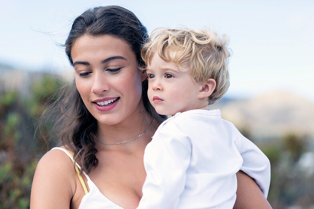 Happy woman carrying her baby