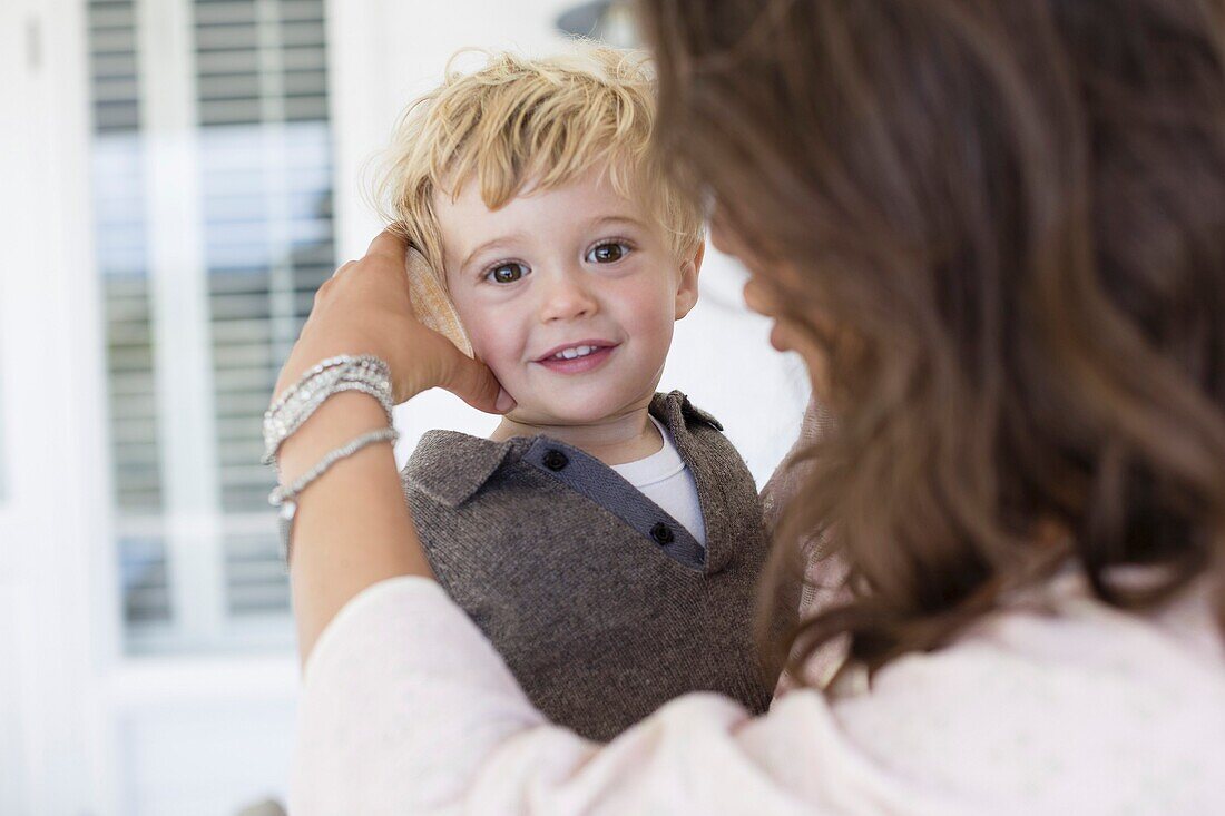 Mother playing with son at home