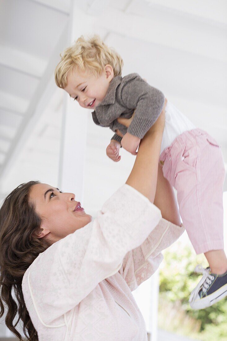 Mother playing with son at home