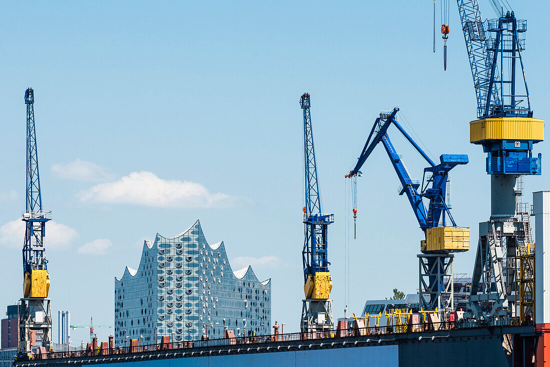 The concert hall Elbphilharmonie framed by cranes of the shipyard Blohm and Voss, Hamburg, Germany