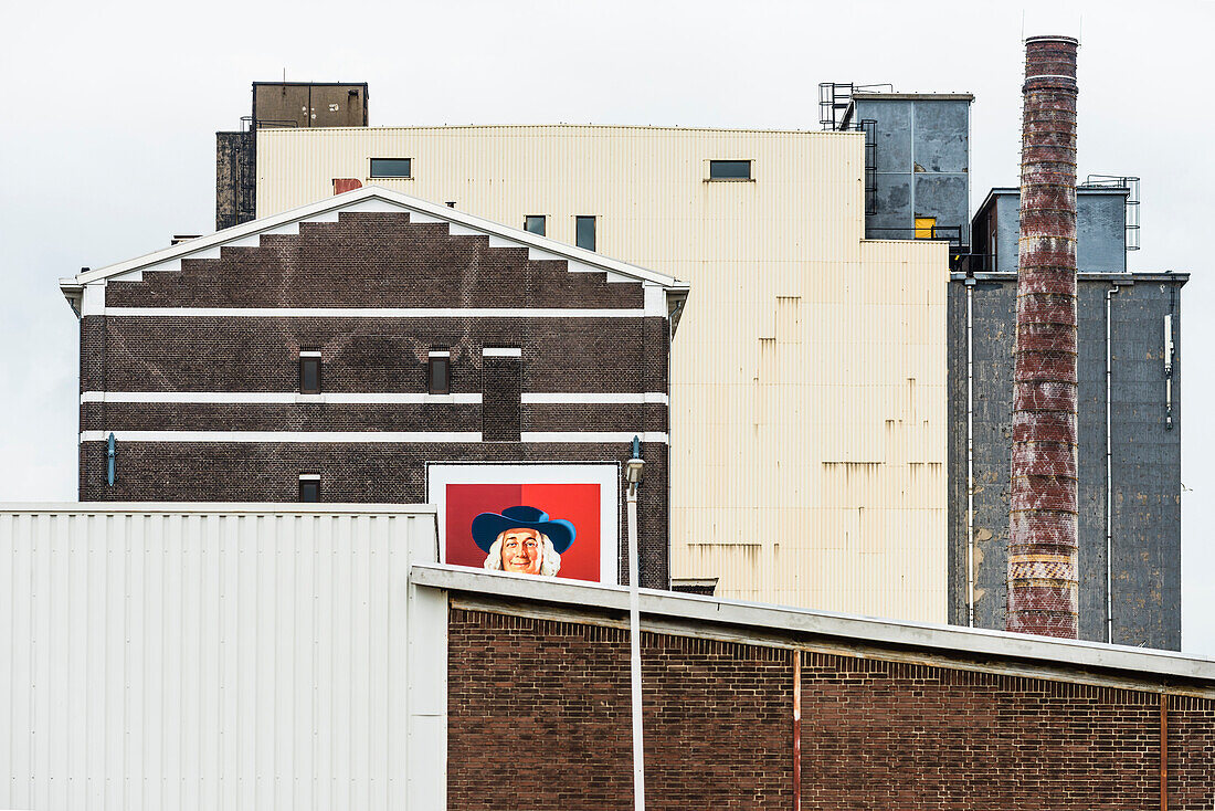 Portrait of a man on an advertisement on buildings in the harbour and industrial zone, Rotterdam, Netherlands