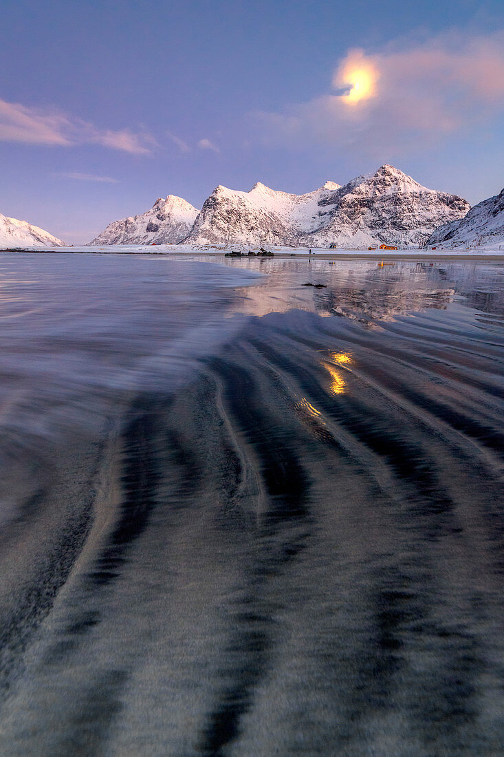 Full moon reflected in the icy sea around the surreal Skagsanden beach, Flakstad, Nordland county, Lofoten Islands, Arctic, Norway, Scandinavia, Europe