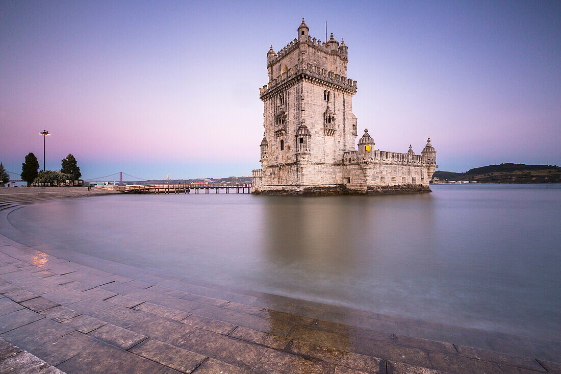 Colorful dusk on the Tower of Belem, UNESCO World Heritage Site, reflected in Tagus River, Belem, Lisbon, Portugal, Europe