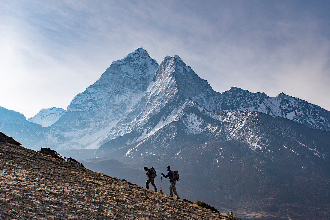 Trekkers climb a small peak above Dingboche in the Everest region in time to see the sunrise, with Ama Dablam in the distance, Himalayas, Nepal, Asia