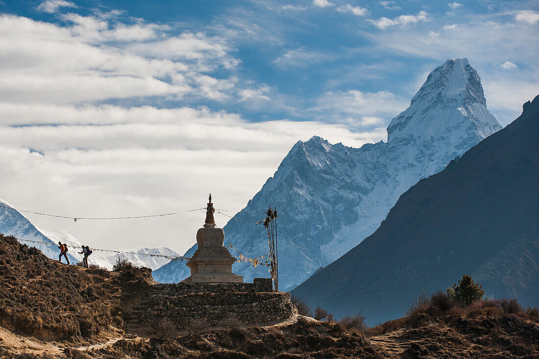 Trekkers near a chorten in the Everest region with the peak of Ama Dablam in the distance, Himalayas, Nepal, Asia